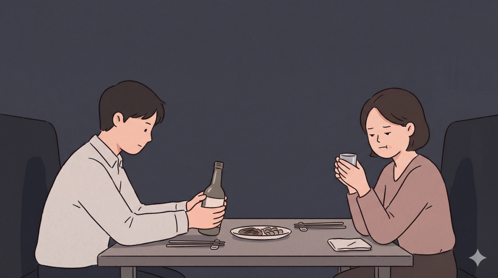 Korean drinking etiquette expressed through two hands, a small glass, and careful distance between two people at a table.