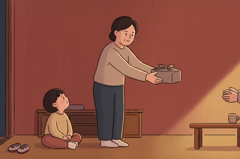 A young child watching an adult's two-handed gesture in a Korean home setting, illustrating the quiet transmission of korean etiquette giving and receiving across generations.